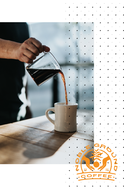 Someone pouring coffee into a mug